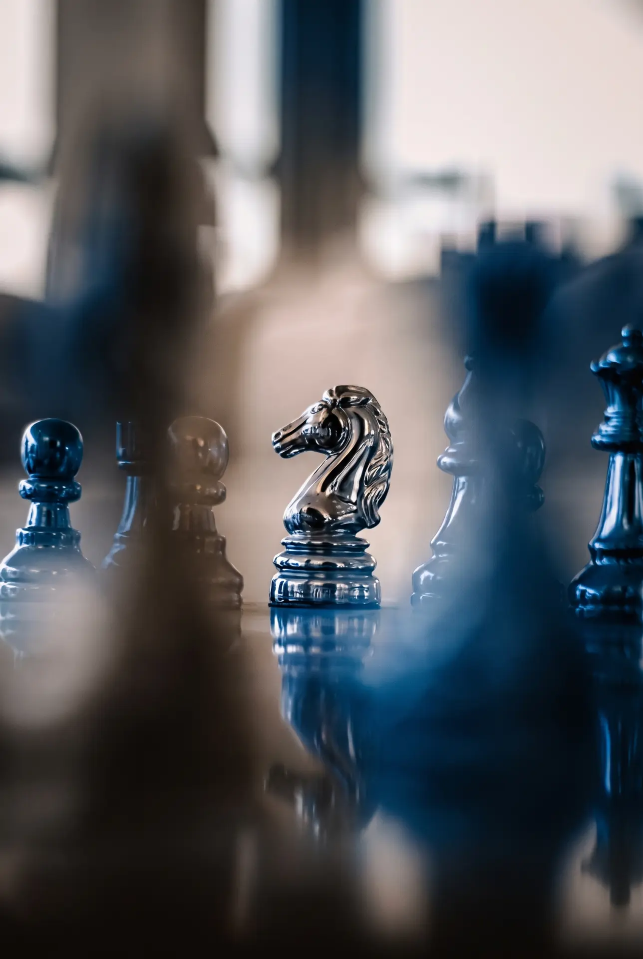 Chess pieces on a board in soft blue light