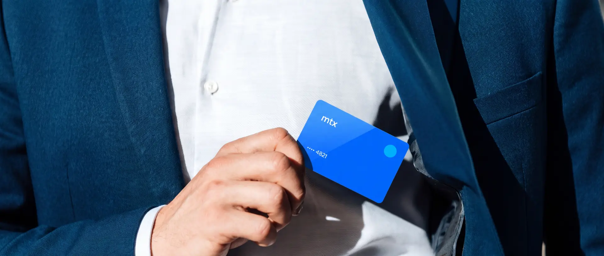 Blue MTX card being pulled from the inside pocket of a blue suit jacket