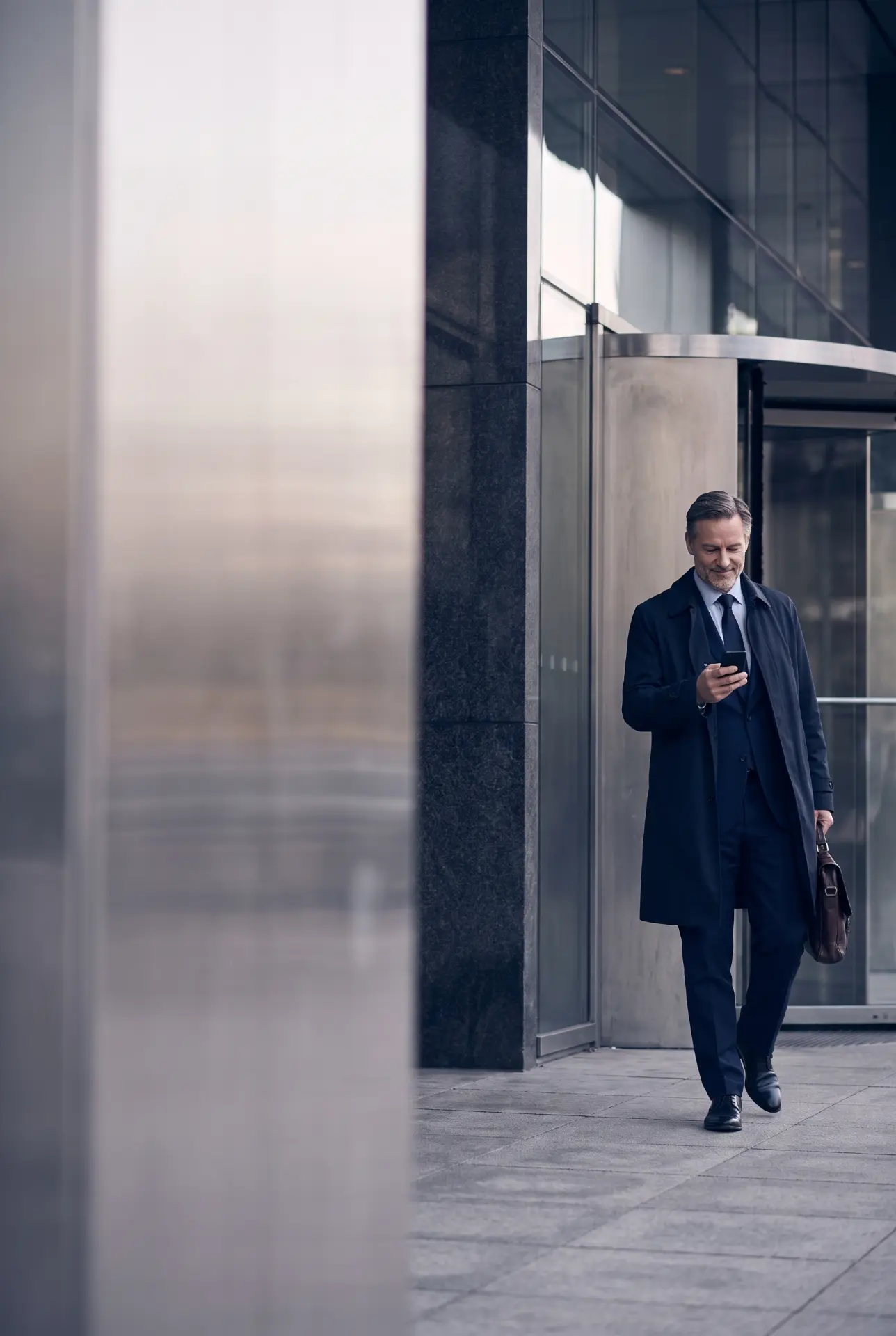 A client checking a payment confirmation outside an office building